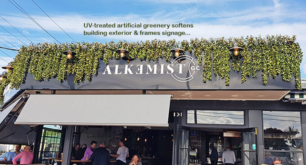 UV-treated artificial greenery softens Cafe facade & frames signage...