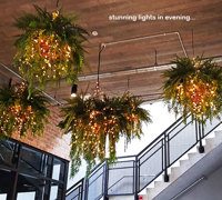 Lush green & dazzling lights- huge artificial hanging-baskets in shopping centre