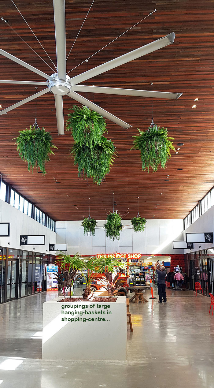 Lush green & dazzling lights- huge artificial hanging-baskets in shopping centre