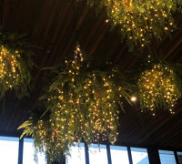 Lush green & dazzling lights- huge artificial hanging-baskets in shopping centre