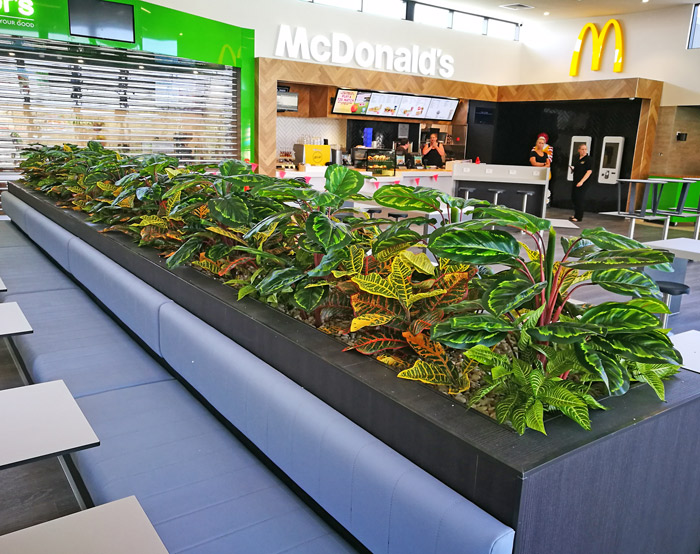 seating planter has a bright mix of greenery to compliment surroundings