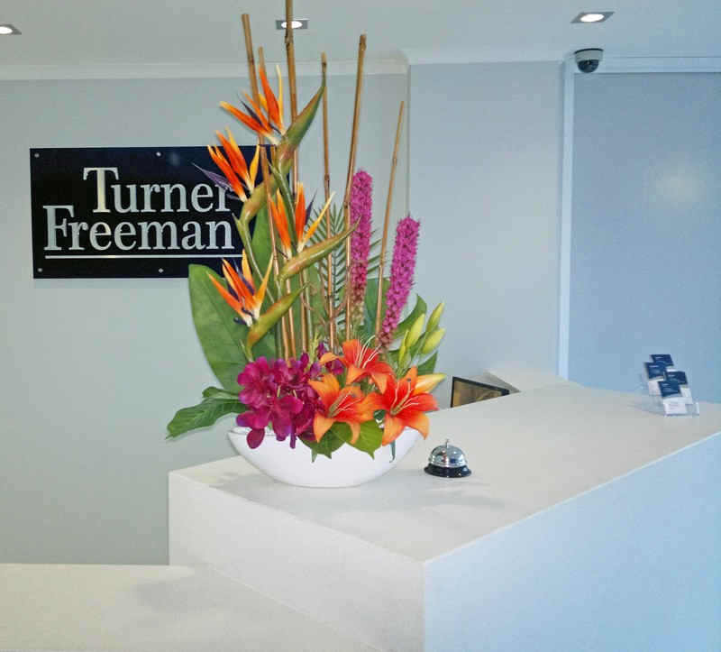 bright, modern floral greeting on reception desk