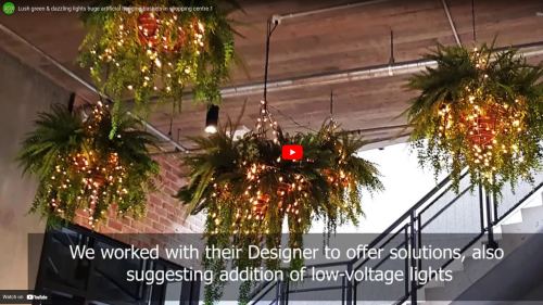 Lush green & dazzling lights- huge artificial hanging-baskets in shopping centre