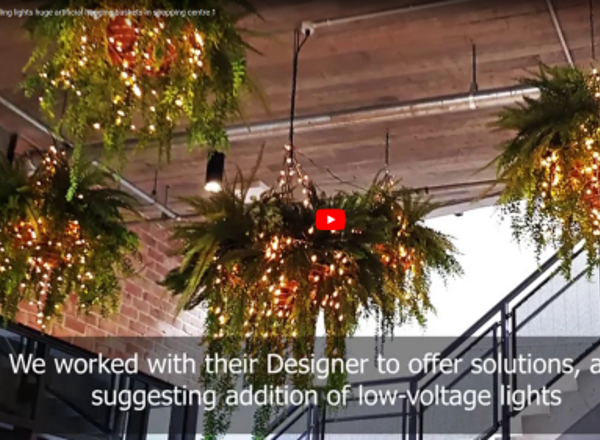 Lush green & dazzling lights- huge artificial hanging-baskets in shopping centre