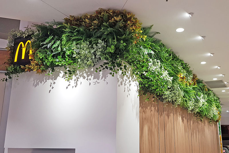 food court entrance hi-lighted by welcoming green-walls