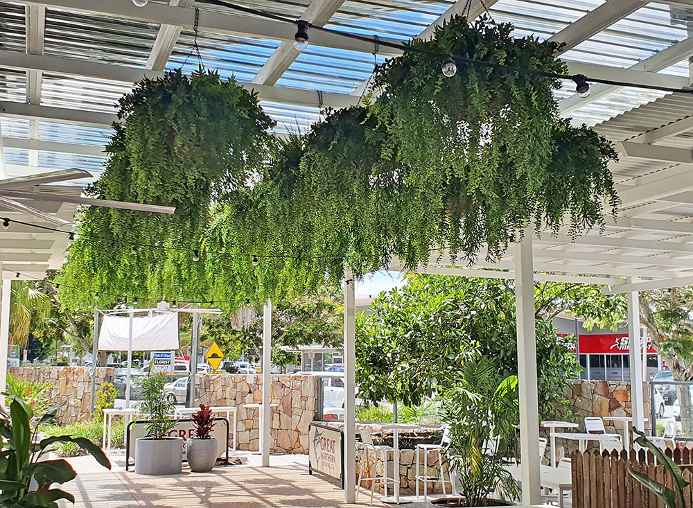 sunny beer-garden with sun-tolerant hanging-baskets  