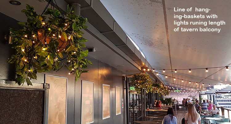 Hanging-Baskets with lights brighten up marina restaurant... image 4