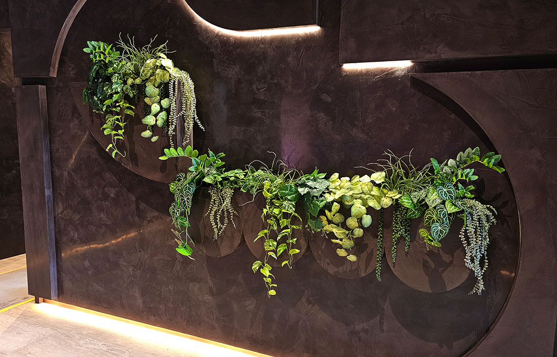 an unusual planter in office foyer with soft, mixed foliages 
