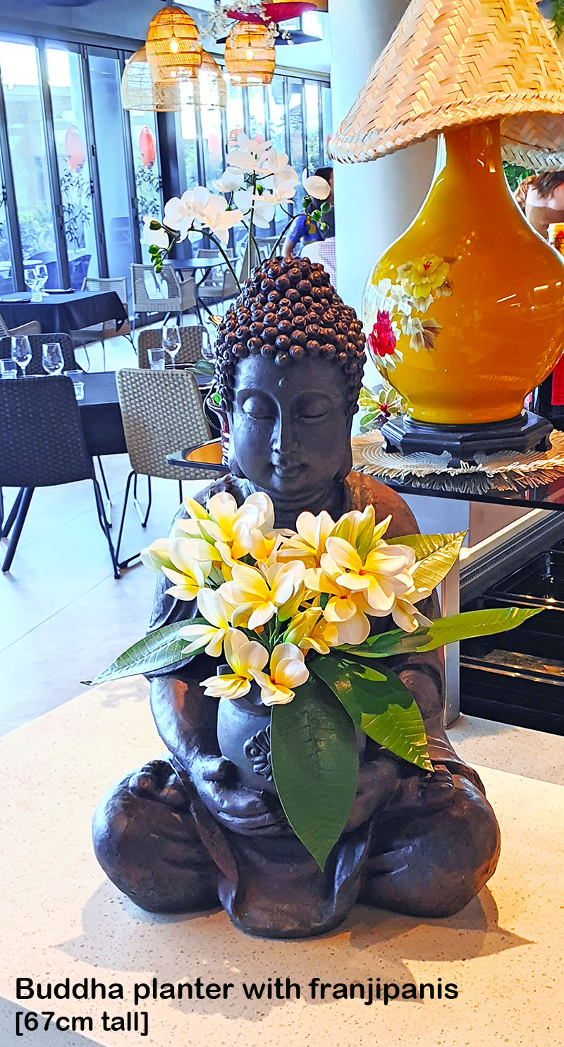 buddha statue with orchids