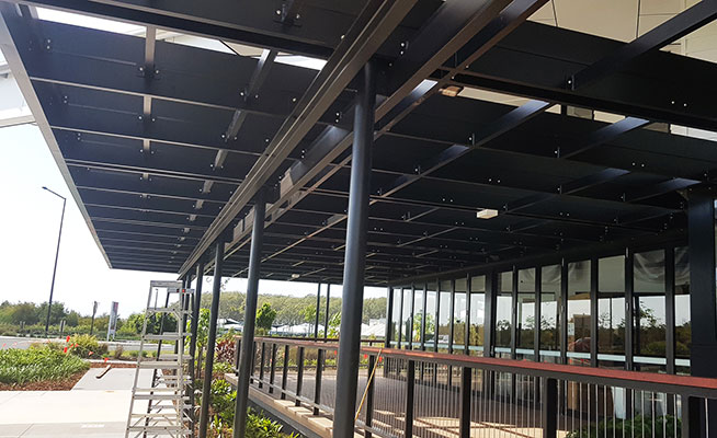 Hanging-Baskets transform new Tavern balcony from drab to cool green...