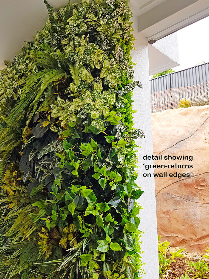 Ugly block support walls turned into lush green-screens with artificial plants