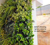 Ugly block support walls turned into lush green-screens with artificial plants