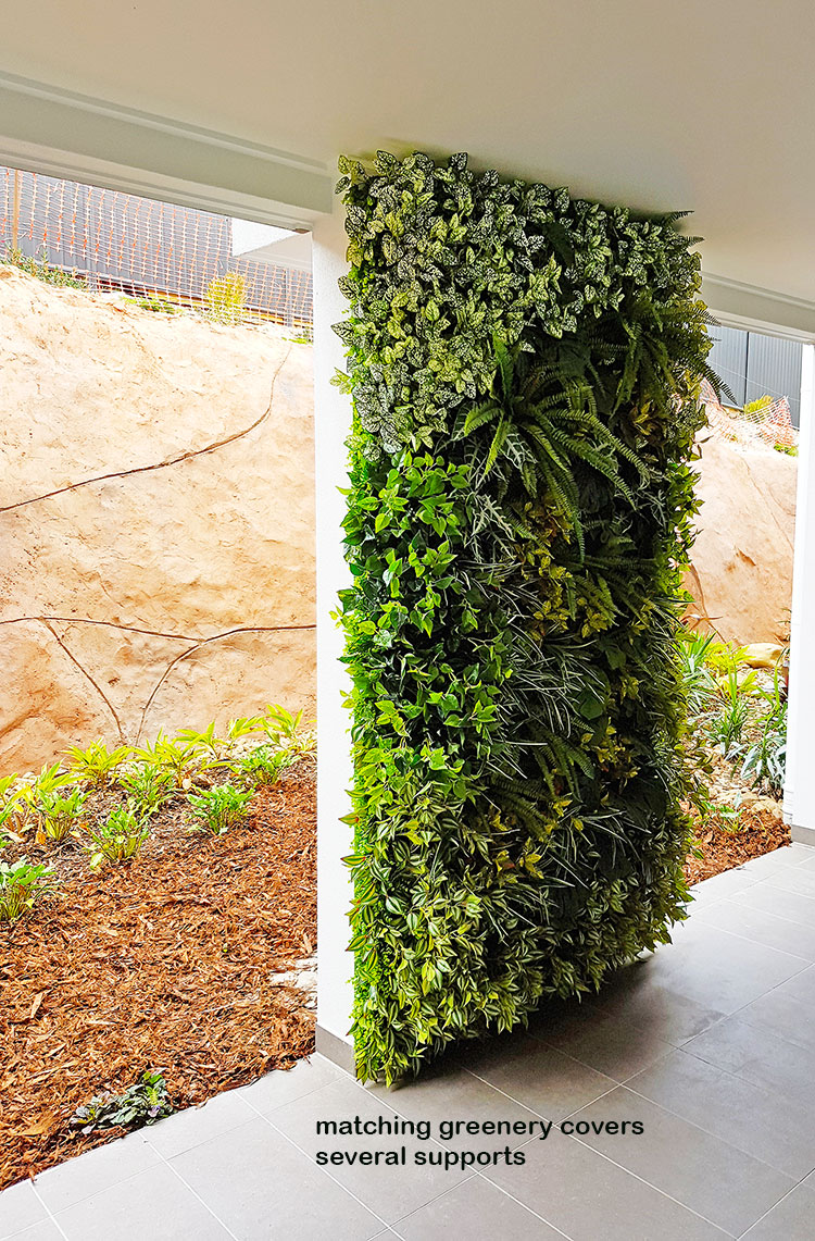 Ugly block support walls turned into lush green-screens with artificial plants