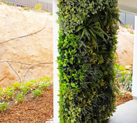 Ugly block support walls turned into lush green-screens with artificial plants