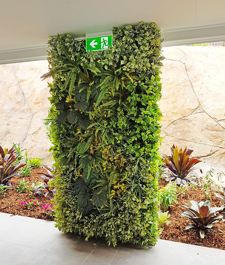 Ugly block support walls turned into lush green-screens with artificial plants