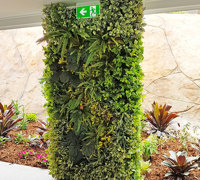 Ugly block support walls turned into lush green-screens with artificial plants