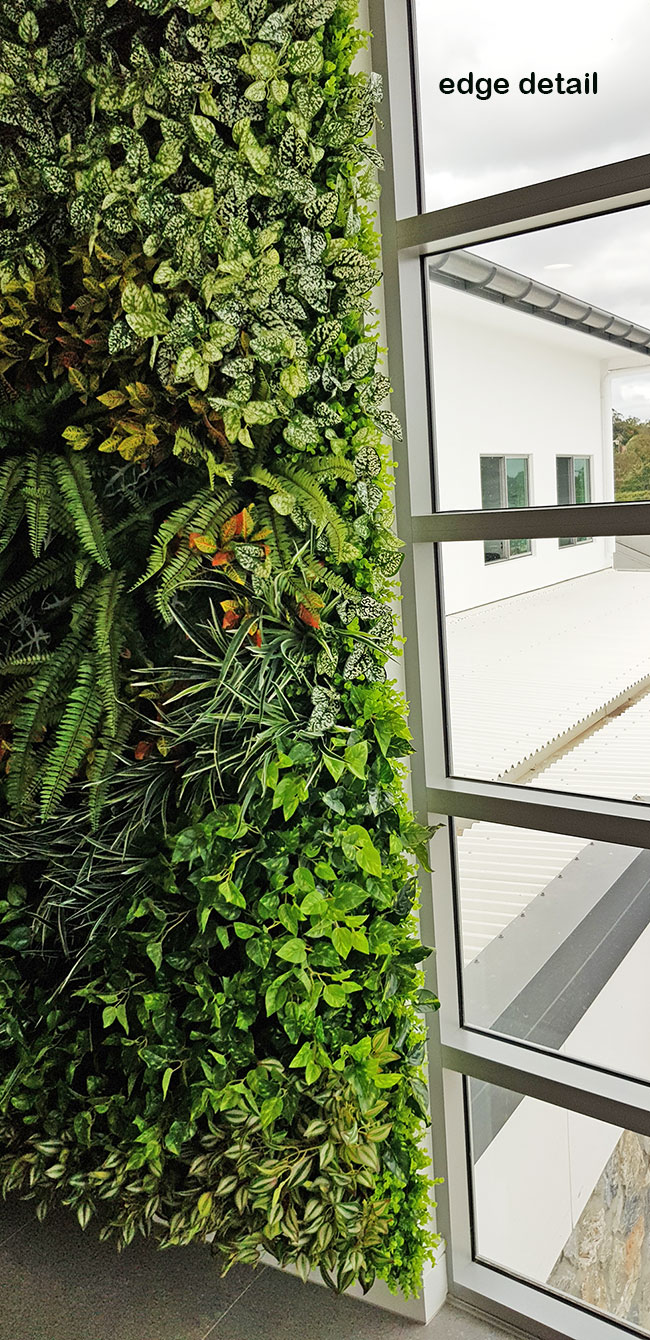 Ugly block support walls turned into lush green-screens with artificial plants