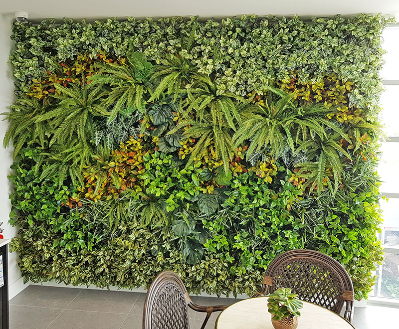 Ugly block support walls turned into lush green-screens with artificial plants