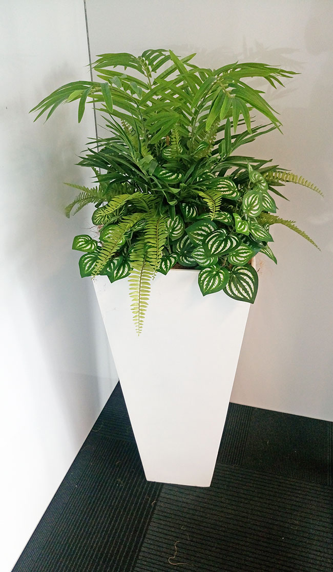Assorted office planters with matching greenery mixes...