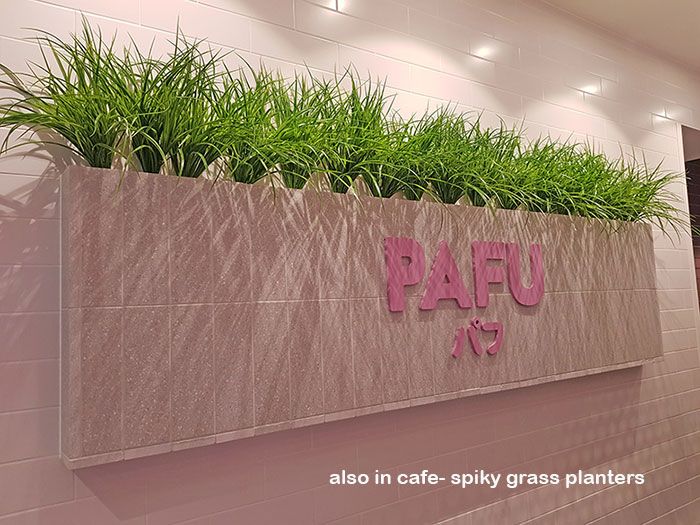 Cafe uses artificial green-vines for privacy screens & pergolas